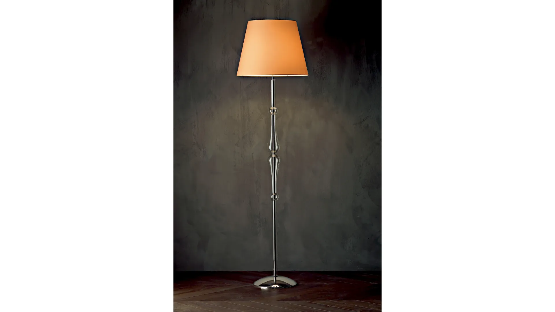 Lampada da terra Miss con struttura cromata,  stelo sagomato in pirex trasparente e paralume in tessuto di Le Fablier